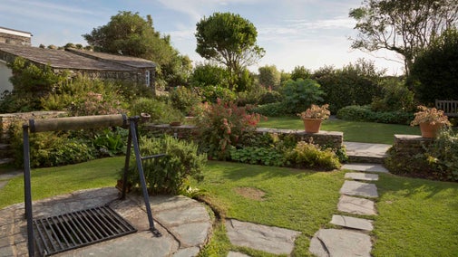View of the garden and well to the rear of Tintagel Old Post Office, Cornwall.
